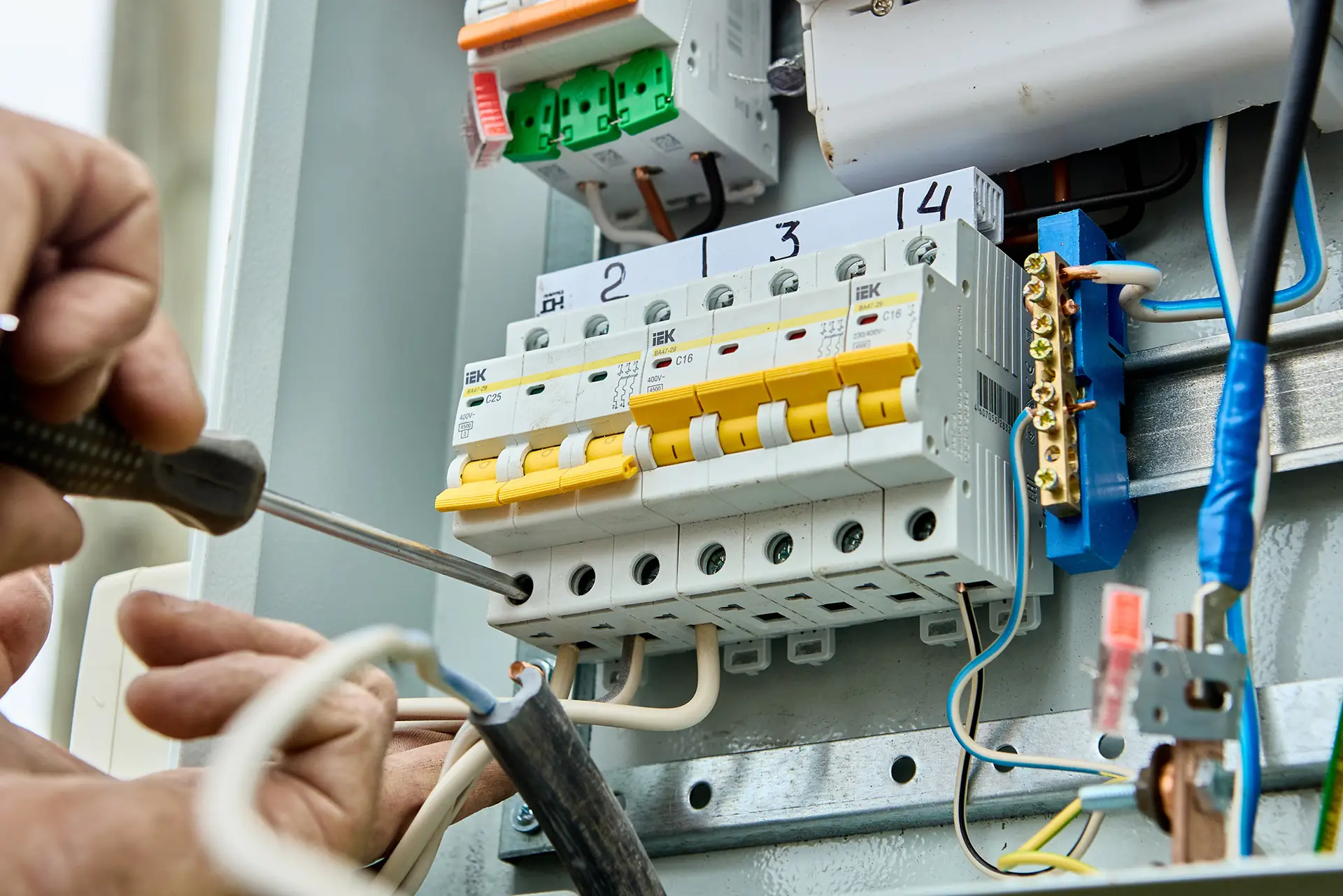 Electrician connecting cables to a consumer unit for a new circuit