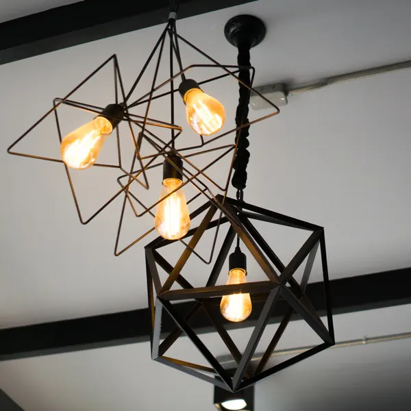 Geometric pendant lights with filament bulbs after a lighting installation